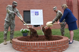 Military leadership burying a time capsule.