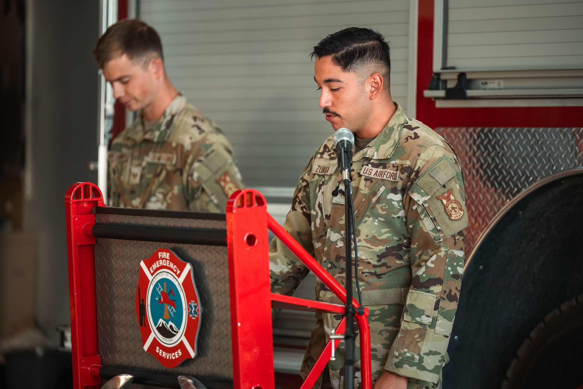 An Airman standing behind a podium giving a speech.
