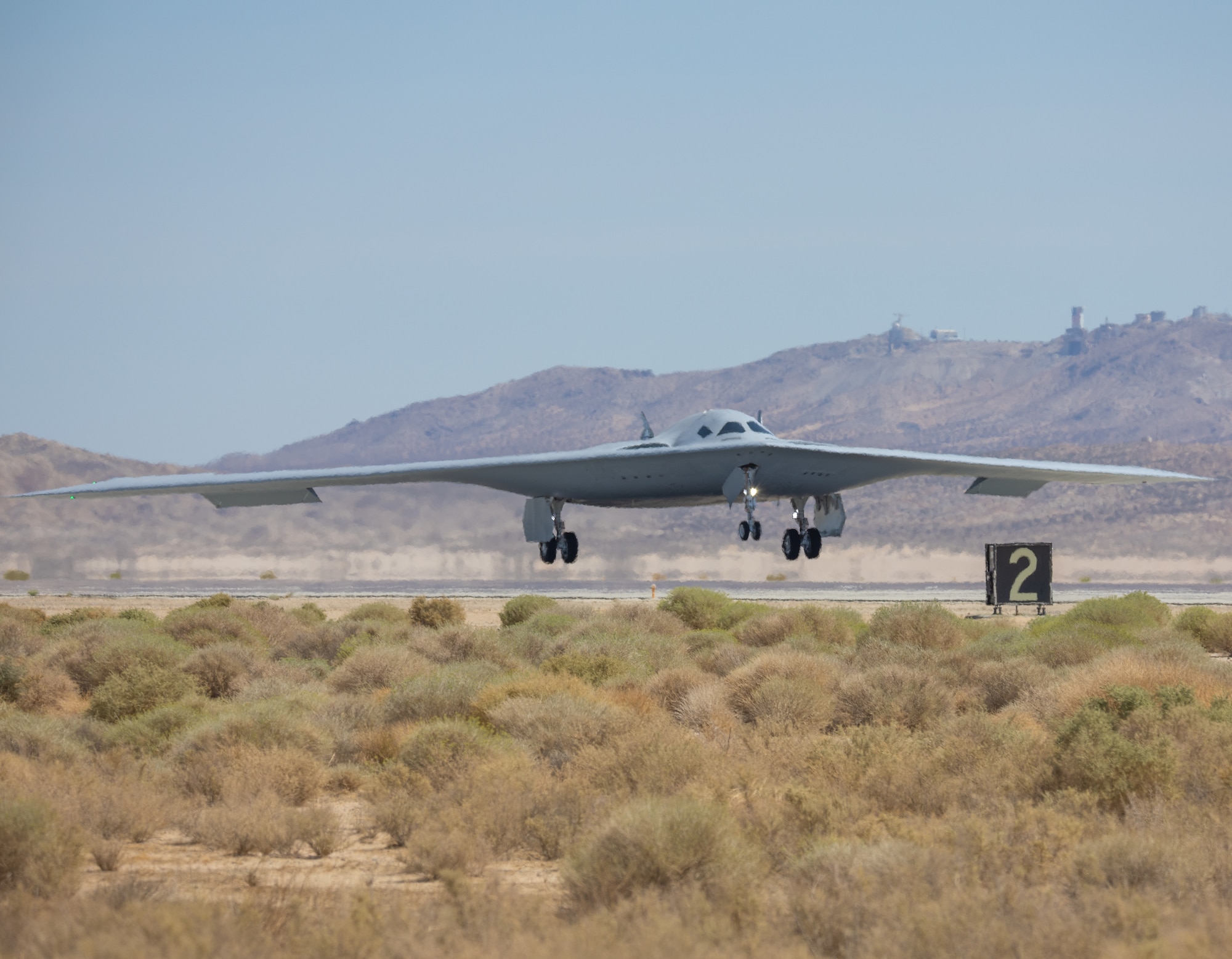 B-21 landing on a runway.