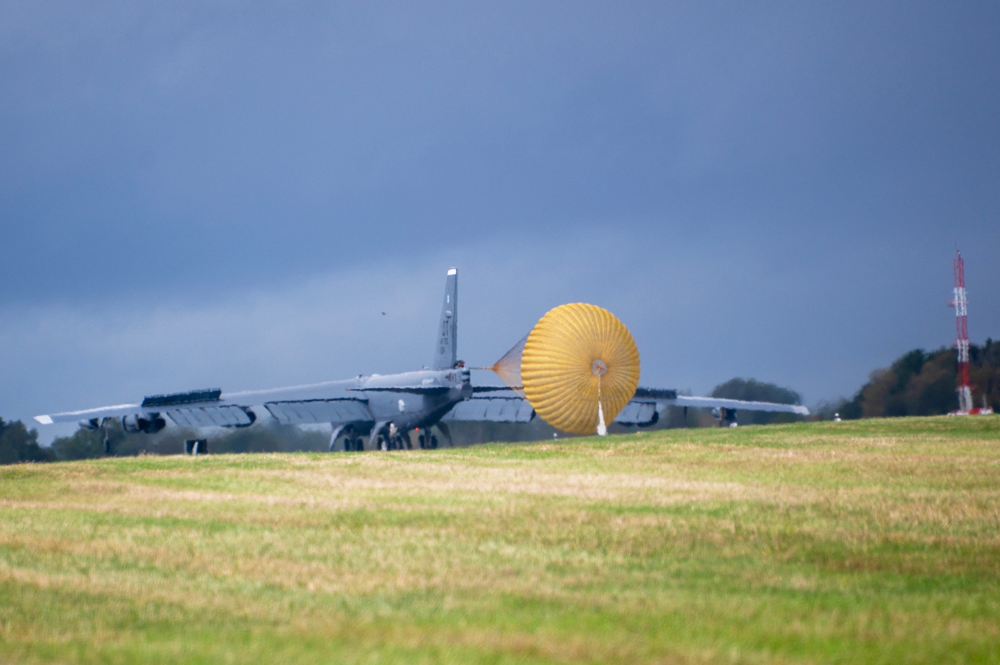 A B-52 Stratofortress lands with its drag chute depoloyed.