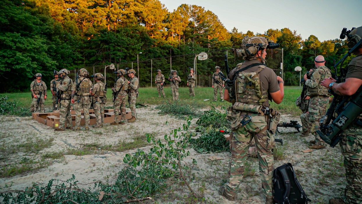 U.S. Soldiers assigned to 3rd Special Forces Group (Airborne), alongside Airman security forces with Air National Guard (ANG), and 824th Base Defense Squadron participate in a sand table brief during Sage Eagle exercise 25-4 on Fort A.P. Hill, Virginia, August 30, 2025. Every year, Sage Eagle exercise tests the agility, precision, and combat readiness of 3rd Special Forces Group (Airborne) Soldiers alongside partner forces as they prepare to face the challenges of real-world missions. (U.S. Army photo taken by Sgt. Edward Randolph)