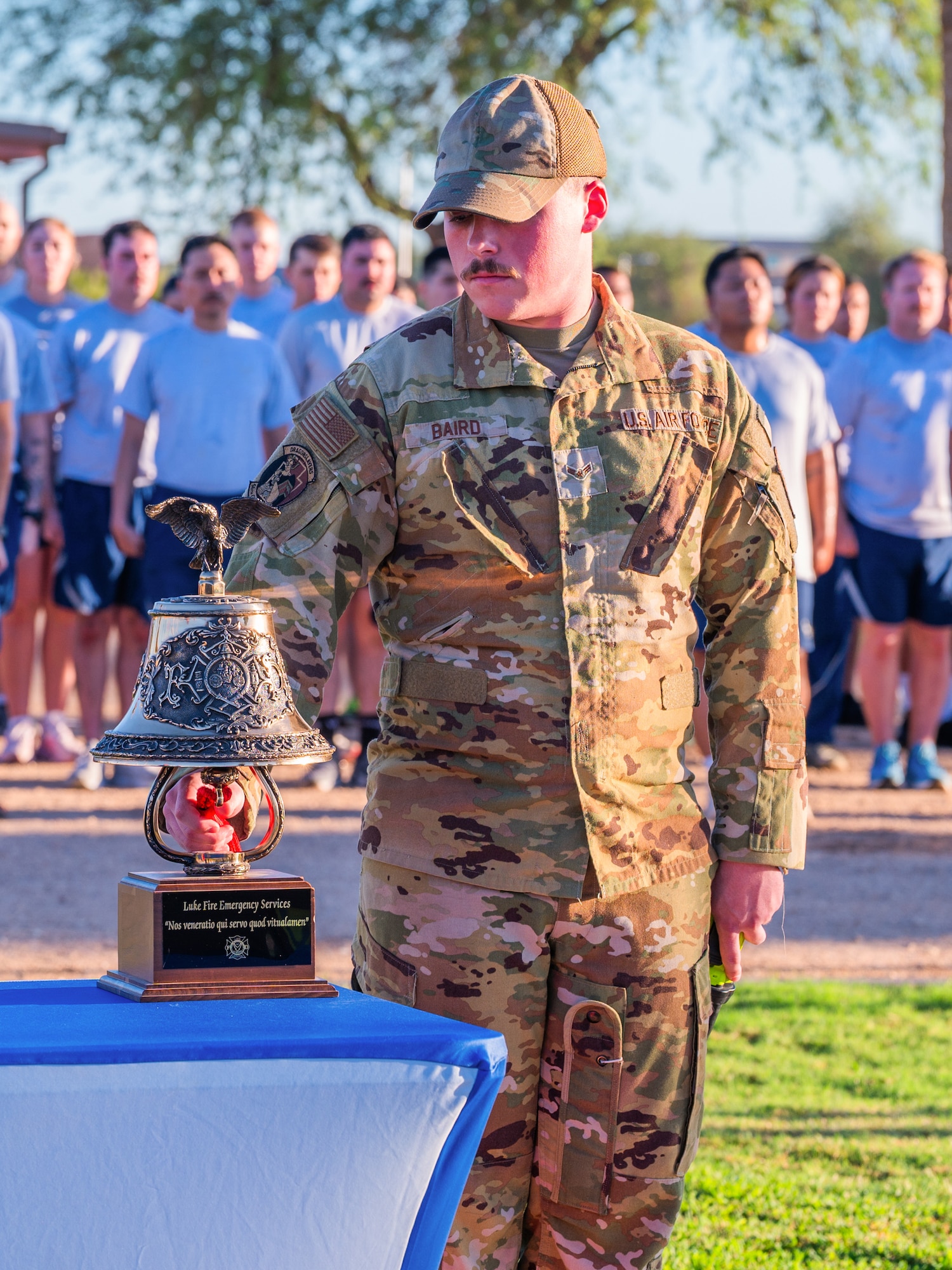 U.S. Air Force Airman 1st Class Andrew Baird, 56th Civil Engineer Squadron firefighter, rings a ceremonial bell during a 9/11 memorial event, Sept. 11, 2025, at Luke Air Force Base, Arizona.