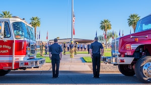 Luke Air Force Base Airmen assigned to the 56th Civil Engineer Squadron salute as a flag is raised during a 9/11 memorial event, Sept. 11, 2025, at Luke Air Force Base, Arizona.