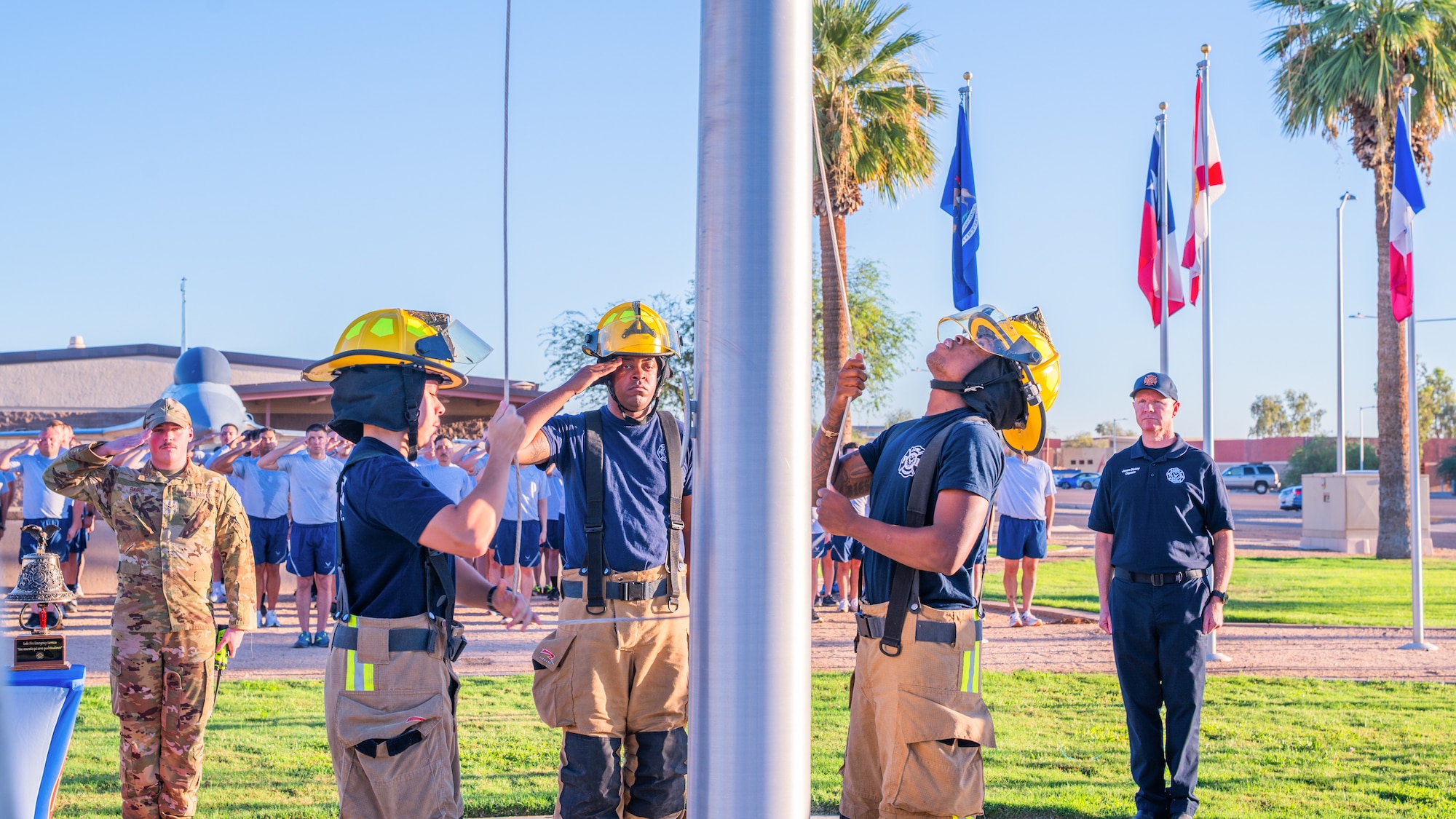 Luke Air Force Base firefighters assigned to the 56th Civil Engineer Squadron raise a flag during a 9/11 memorial event, Sept. 11, 2025, at Luke Air Force Base, Arizona.