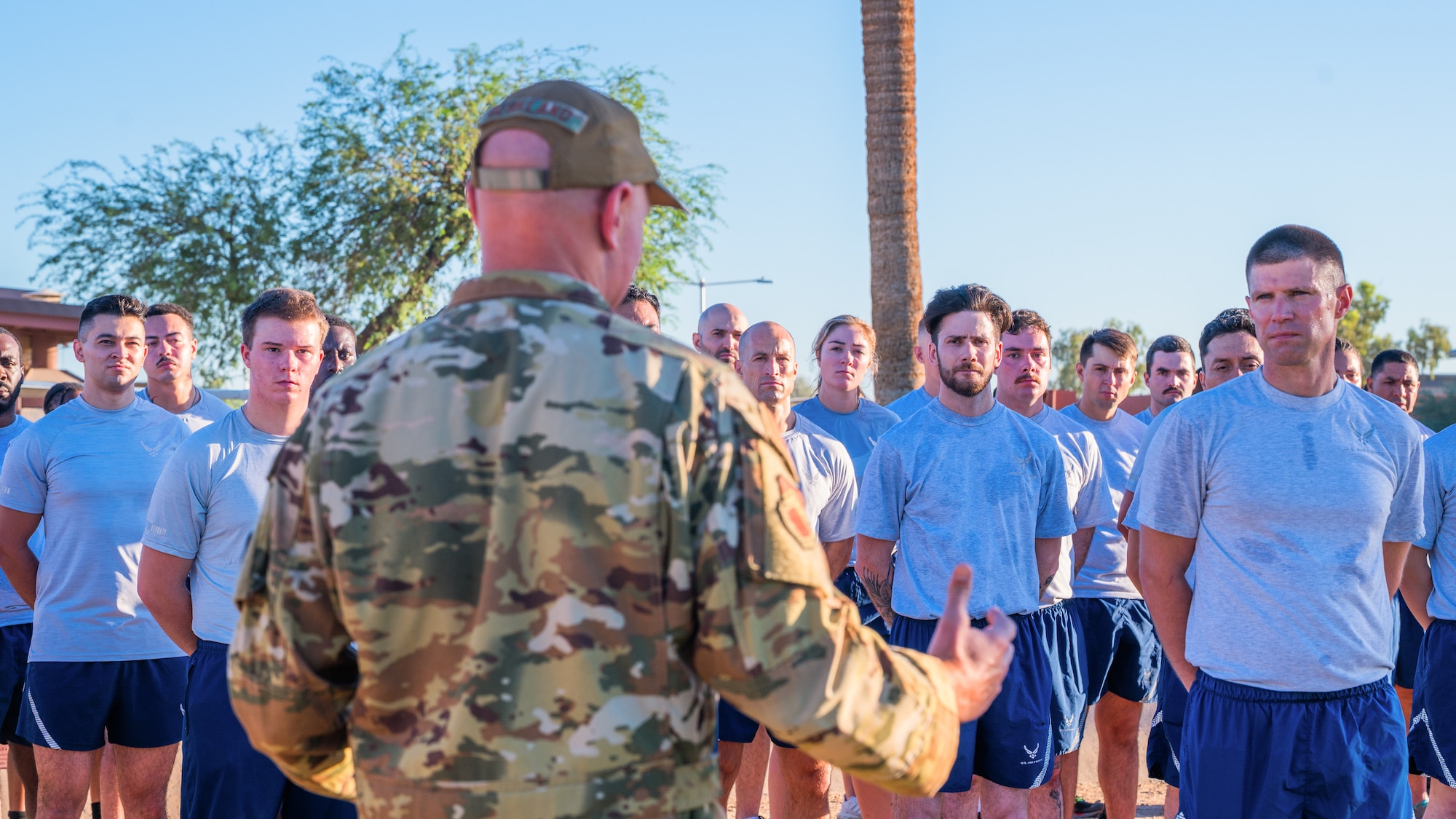 Luke Air Force Base Airmen assigned to the 56th Civil Engineer Squadron listen to an address given by U.S. Air Force Brig. Gen. David Berkland, 56th Fighter Wing commander, during a 9/11 memorial event, Sept. 11, 2025, at Luke Air Force Base, Arizona.