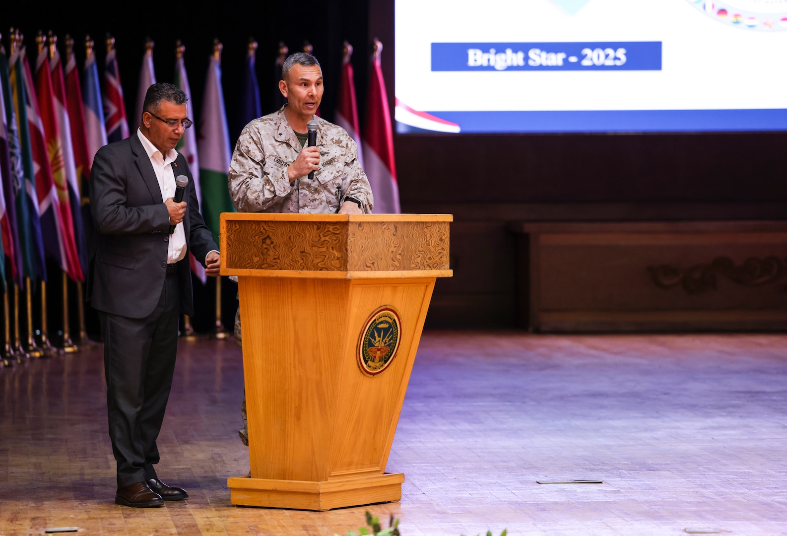 U.S. Marine Corps Brig. Gen. Stephen Lightfoot, right, the commanding general of Task Force 51/5th Marine Expeditionary Brigade, gives opening remarks for the command post exercise during BRIGHT STAR 25 at Mohamed Naguib Military Base (MNMB), Egypt, Sept. 1, 2025. Exercise BRIGHT STAR 25 is a multilateral U.S. Central Command (USCENTCOM) command-post exercise, field training exercise and senior leader seminar, held in the Arab Republic of Egypt along with other partner nations. Participation strengthens military-to-military relationships between U.S. forces and our Egyptian partners in the USCENTCOM area of responsibility, as well as other participating nations. The exercise enhances regional security and stability by responding to modern-day security scenarios. (U.S. Marine Corps photo by Sgt. Angela Wilcox)
