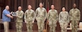 U.S. Army TMDE Activity award presentation to the Indiana Army National Guard CSMS calibration team. From left: Larry Thompson, National Guard Bureau TMDE program analyst; Chief Warrant Officer 2 Whitney Lake; Sgt. 1st Class Phillip Morgan; Staff Sgt. Austin Schmidt; Sgt. 1st Class Gregory Myers; Sgt. Su Lee; Sgt. Jacob Wells.