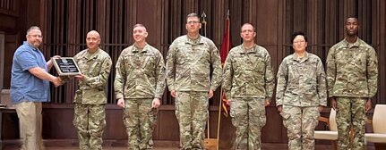 U.S. Army TMDE Activity award presentation to the Indiana Army National Guard CSMS calibration team. From left: Larry Thompson, National Guard Bureau TMDE program analyst; Chief Warrant Officer 2 Whitney Lake; Sgt. 1st Class Phillip Morgan; Staff Sgt. Austin Schmidt; Sgt. 1st Class Gregory Myers; Sgt. Su Lee; Sgt. Jacob Wells.