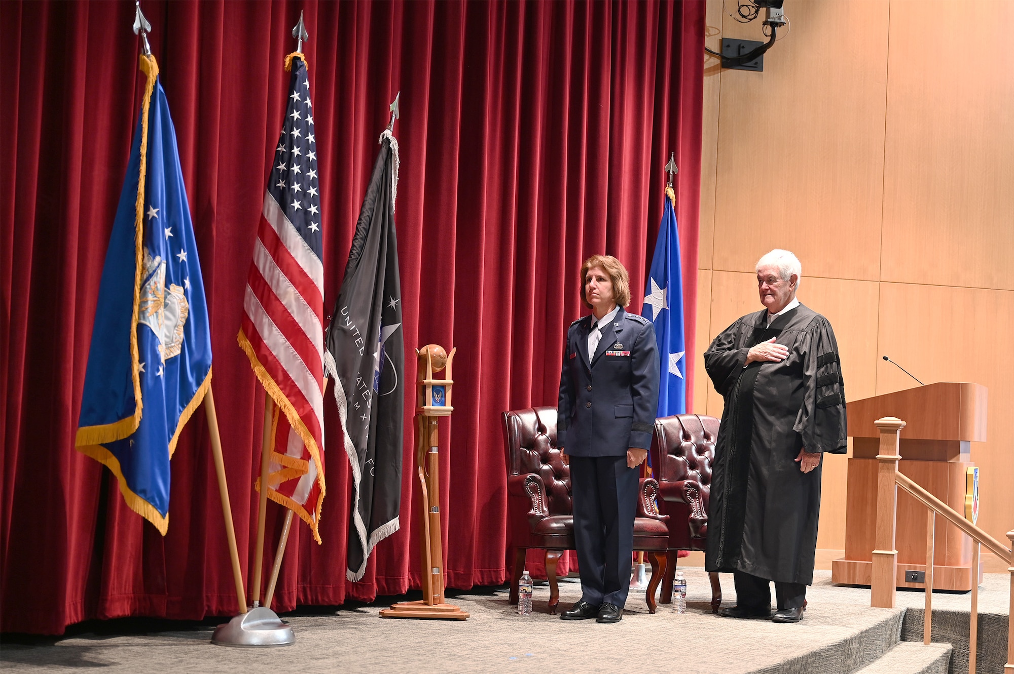 U.S. Air Force Lt. Gen. Andrea D. Tullos, Air University commander and president, and Newt Gingrich, American politician, historian and author, render honors during a formal ceremony at Maxwell Air Force Base, Alabama