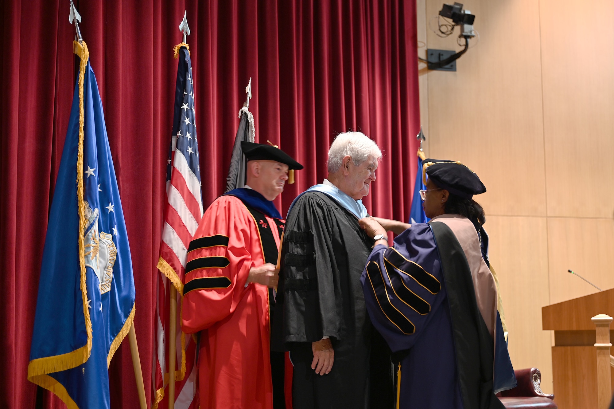 Newt Gingrich, American politician, historian and author, is adorned with his doctorate hood after being presented with his honorary doctorate from Air University at Maxwell Air Force Base, Alabama