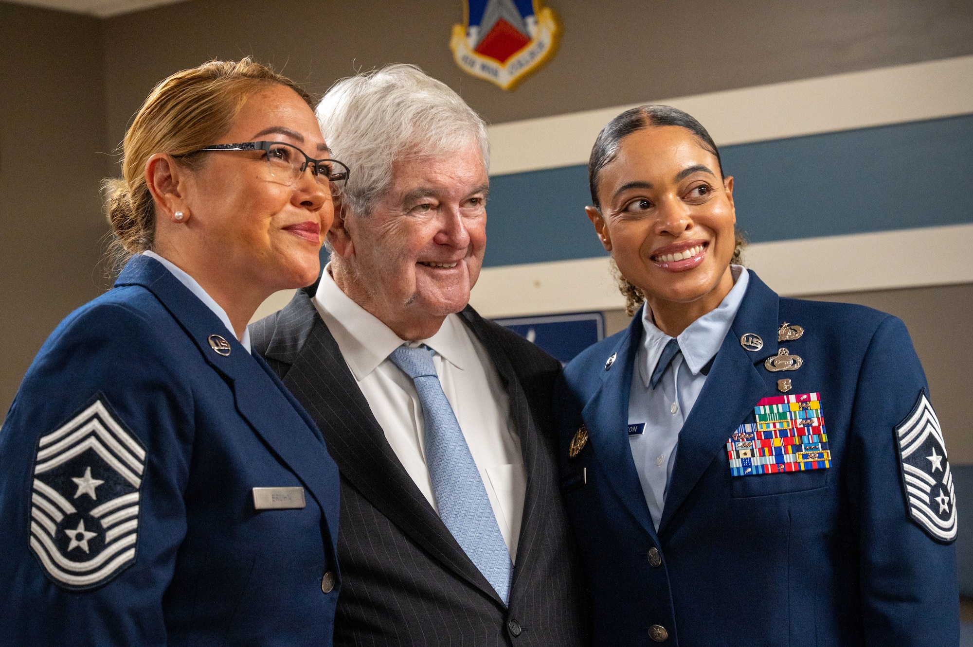 Newt Gingrich, Former Speaker of the House, poses for a photo with Airmen attending his honorary doctorate ceremony
