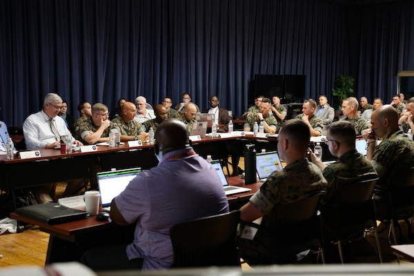 OPLOG Wargame participants present key findings during the final out-brief of the Marine Corps Logistics Command Operational Logistics Wargame at Marine Corps Logistics Base Albany, Ga., 12 Sept. 2025. The two-week exercise brought together 104 participants from 13 organizations to test operational-level logistics using scenario-driven exercises combined with data-driven analysis and an advanced wargaming platform.
