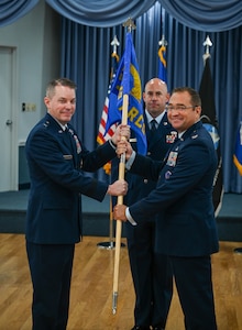 Brig. Gen. Jeffrey W. Nelson, Air Force Accessions Center and Air Force Recruiting Service commander, Joint Base San Antonio-Randolph, Texas, passes guidon to Col. Sean “Metro” Fellows during 367th Recruiting Group Assumption of Command ceremony August 22, 2025, at Robins Air Force Base, Georgia. (U.S. Air Force photo by Isaac Jones)