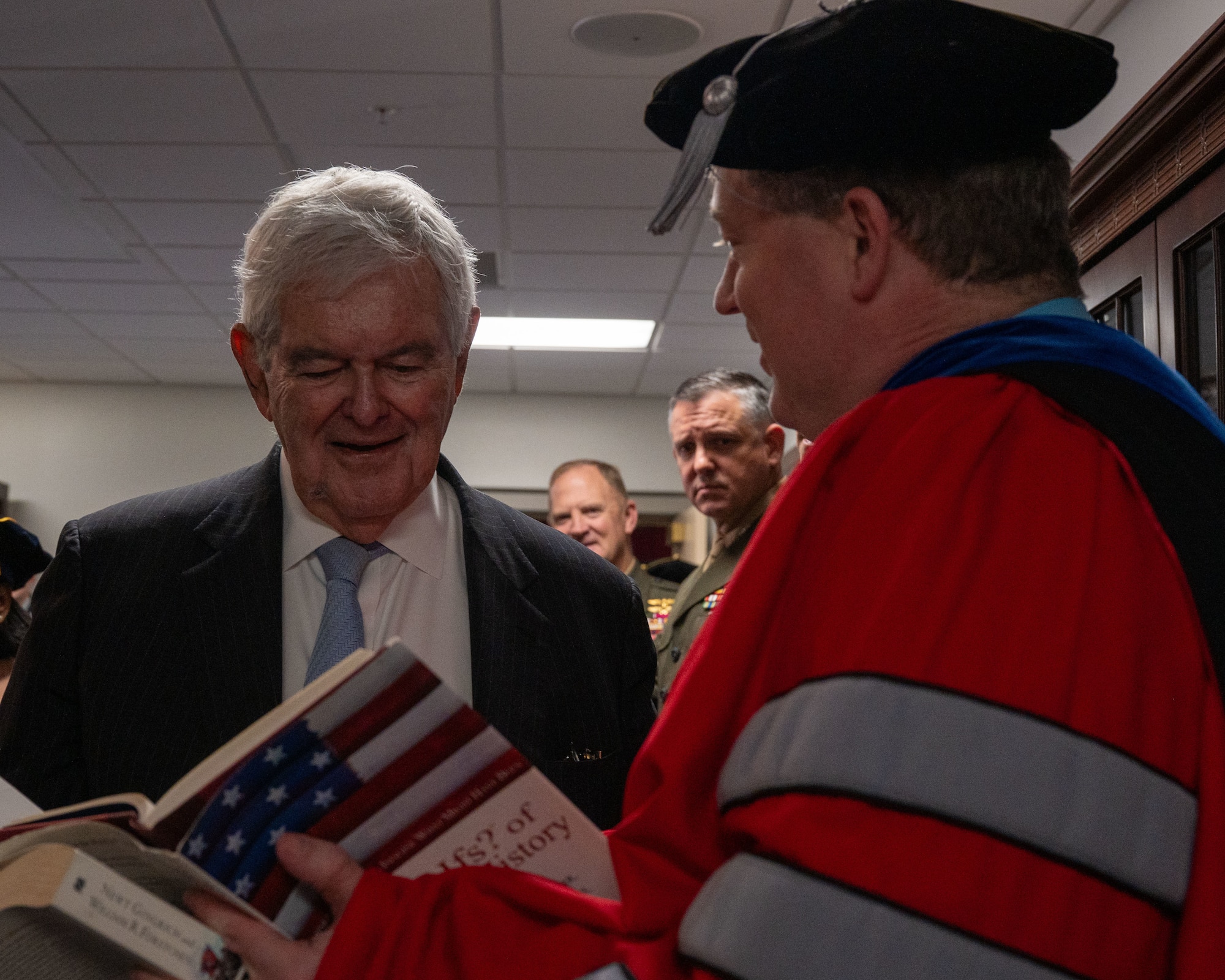 Newt Gingrich, Former Speaker of the House, interacts with guests attending his honorary doctorate ceremony at Maxwell Air Force Base, Alabama