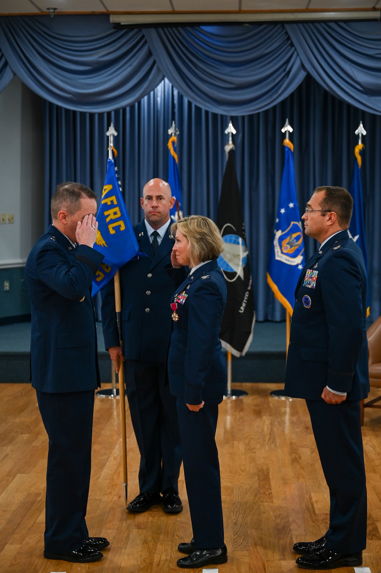 Brig. Gen. Jeffrey W. Nelson, Air Force Accessions Center and Air Force Recruiting Service commander, Joint Base San Antonio-Randolph, Texas, salutes a farewell to Col. Michelle Coumbs, outgoing 367th Recruiting Group commander, as Col. Sean "Metro" Fellows, incoming 367th RCG commander, awaits assumption of duties, during 367th RCG Assumption of Command ceremony August 22, 2025, at Robins Air Force Base, Georgia.(U.S. Air Force photo by Isaac Jones)