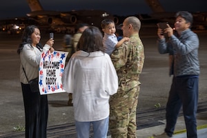 U.S. Air Force Capt. Jooney Jung, 7th Airlift Squadron pilot, reunites with his family during the 7th Expeditionary Airlift Squadron’s redeployment to Joint Base Lewis-McChord, Washington, Sept. 7, 2025.