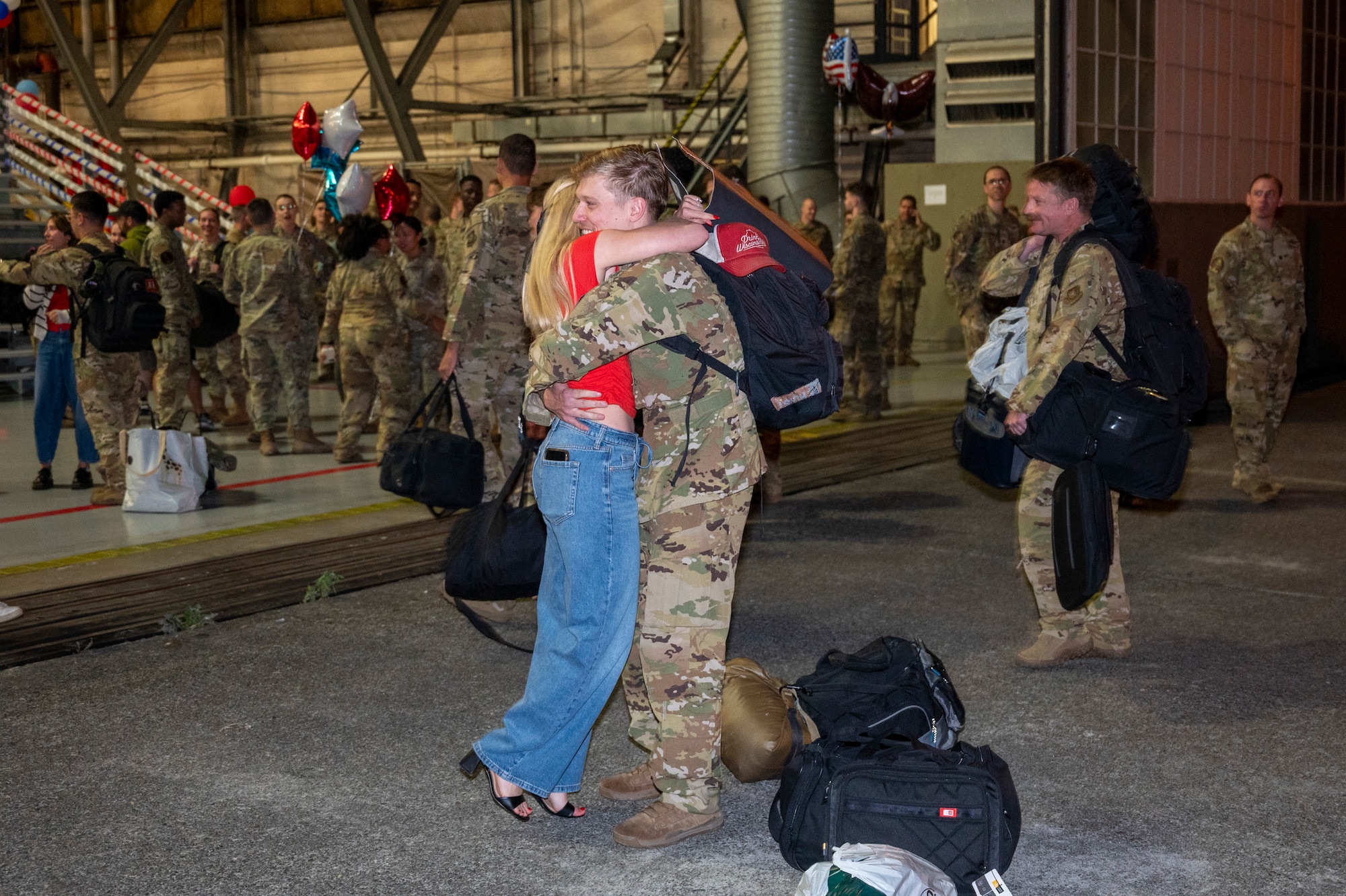 U.S. Air Force Capt. Mitchell Brunke, 7th Airlift Squadron pilot, hugs his spouse during the 7th Expeditionary Airlift Squadron’s redeployment to Joint Base Lewis-McChord, Washington, Sept. 7, 2025.