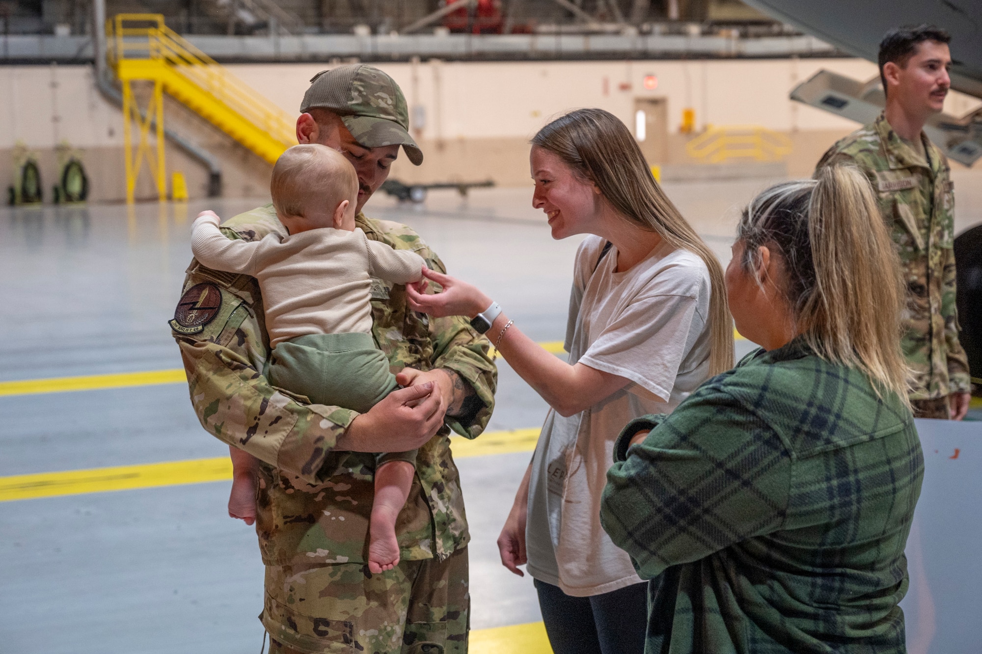 U.S. Air Force Senior Airman Levi Bowden, 62d Aircraft Maintenance Squadron flying crew chief, reunites with his family during the 7th Expeditionary Airlift Squadron’s redeployment to Joint Base Lewis-McChord, Washington, Sept. 7, 2025.