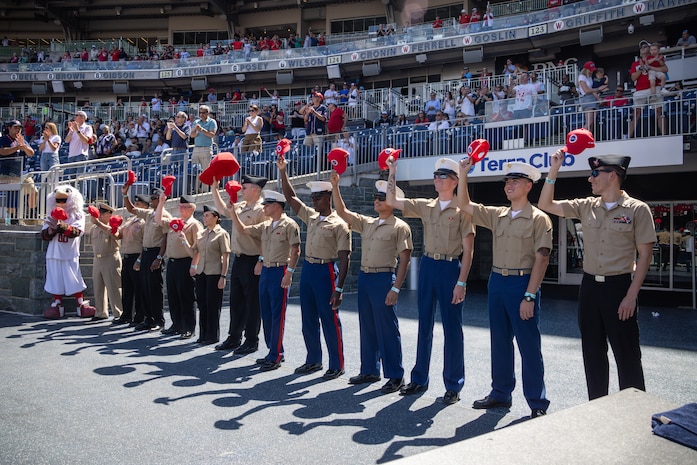 U.S. Marines and Sailors with Chemical Biological Incident Response Force and Aegis Training and Readiness Center, Dahlgren, wave their baseball caps as they are recognized during a Washington Nationals game at Nationals Park in Washington, D.C., Sept. 3, 2025. Through their Salute to Service program, the Washington Nationals honor local military units throughout the Washington, D.C., area, offering service members from all branches the chance to enjoy a game while providing the community an opportunity to recognize their dedication and sacrifice. The event aimed to highlight the service of local military members and strengthen ties with the community. (U.S. Marine Corps photo by Lance Cpl. Amy Espinoza)
