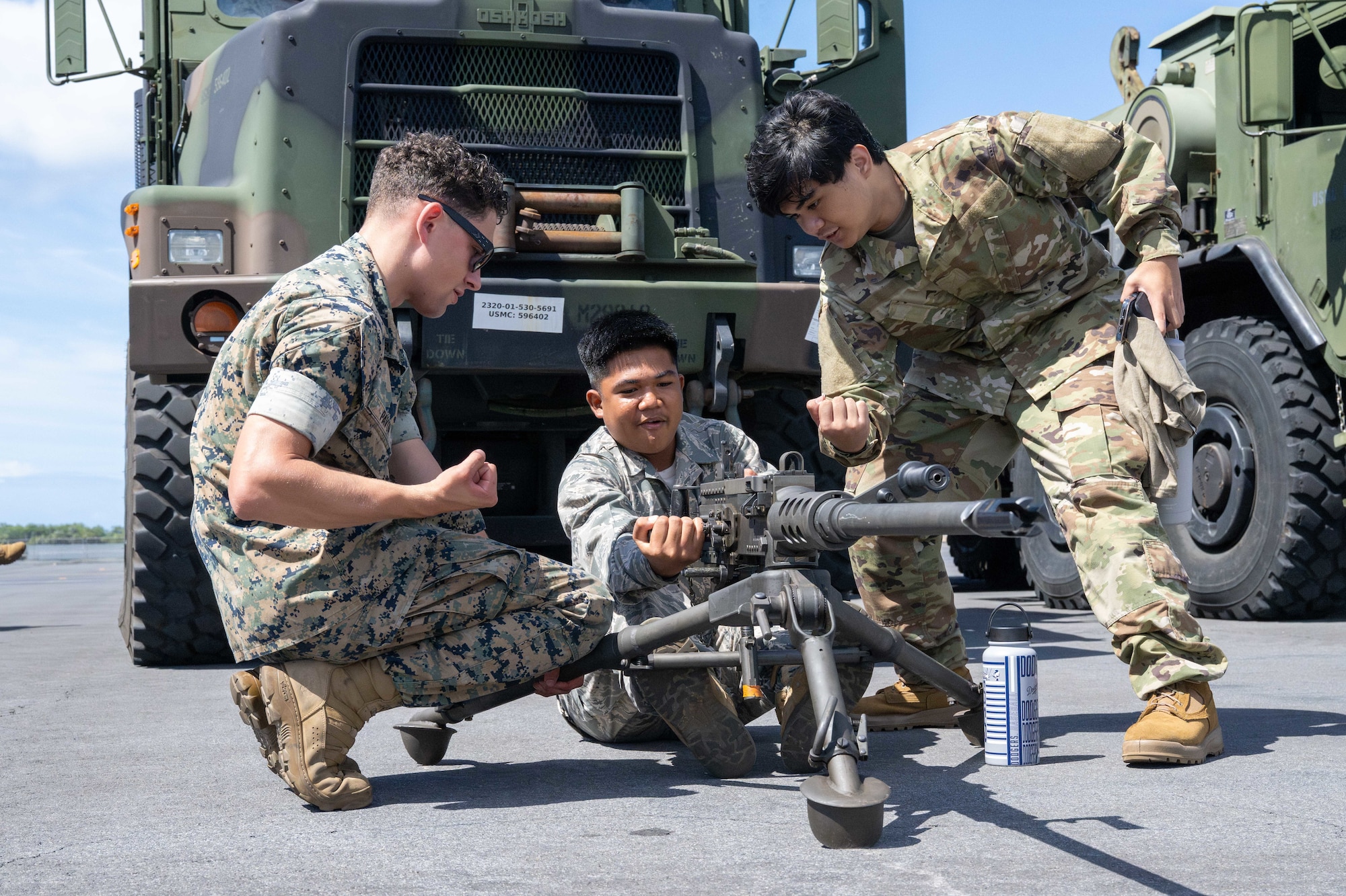 U.S. Air Force Junior Reserve Officer Training Corps cadets interact with a U.S. Marine and equipment during the Wings of Aloha Student Expo.