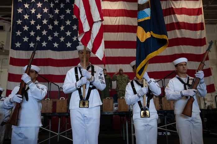 Sailors perform color guard duties during a Sept. 11 memorial service aboard Nimitz-class aircraft carrier USS George Washington (CVN 73) while moored pierside at Commander, Fleet Activities Yokosuka, Sept.  11, 2025.