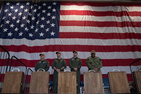 Capt. Timothy Waits, left, commanding officer, Capt. Jason Tarrant, executive officer, Capt. Patrick Blind, prospective executive officer, and Command Master Chief Antonio Roberts, attend a Sept. 11 memorial service aboard Nimitz-class aircraft carrier USS George Washington (CVN 73) while moored pierside at Commander, Fleet Activities Yokosuka, Sept. 11, 2025.