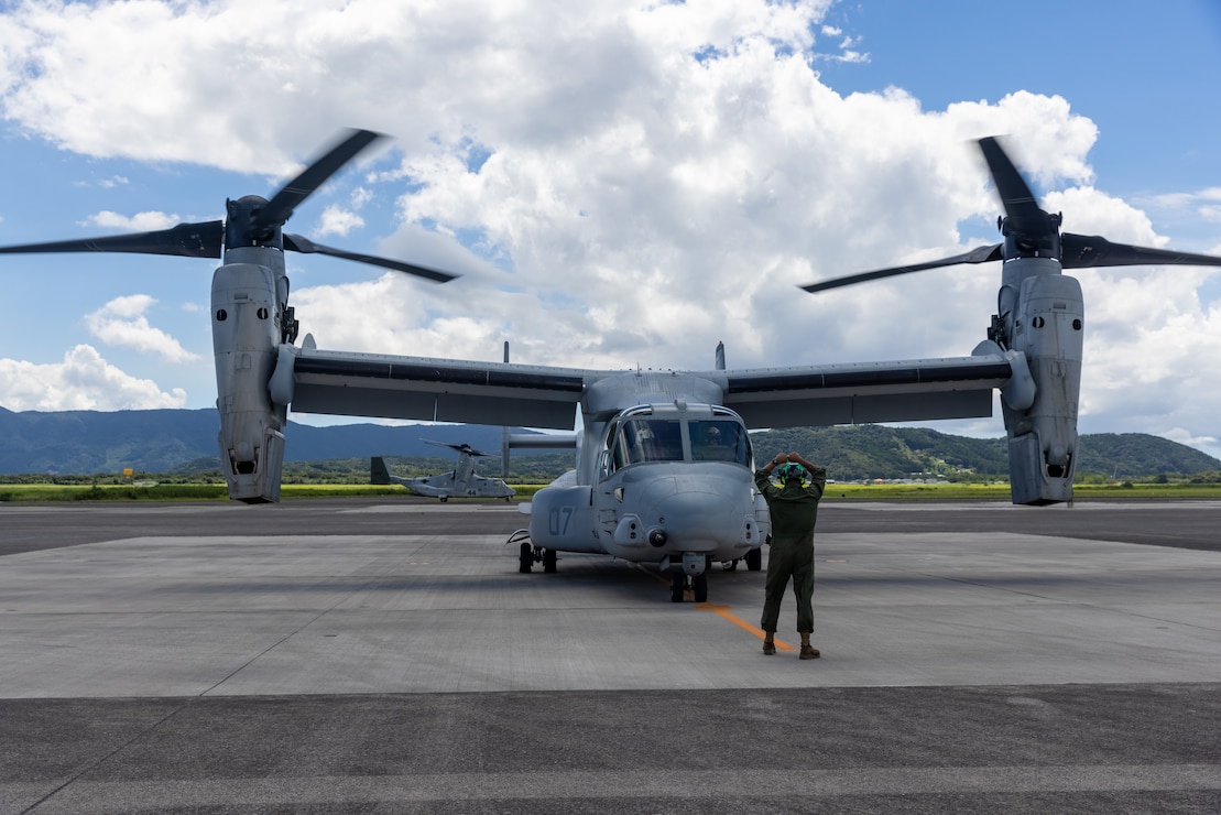 A U.S. Marine with Marine Medium Tiltrotor Squadron (VMM) 262, Marine Aircraft Group 36, 1st Marine Aircraft Wing guides an MV-22B Osprey after landing at Japan Maritime Self-Defense Force Kanoya Air Base, Kagoshima, Japan, Sept. 8, 2025.