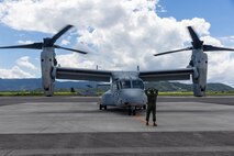 A U.S. Marine with Marine Medium Tiltrotor Squadron (VMM) 262, Marine Aircraft Group 36, 1st Marine Aircraft Wing guides an MV-22B Osprey after landing at Japan Maritime Self-Defense Force Kanoya Air Base, Kagoshima, Japan, Sept. 8, 2025.