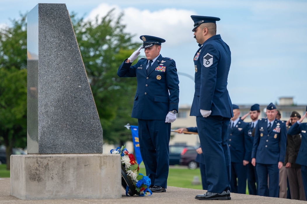 U.S. Air Force Col. Paul Davidson, 35th Fighter Wing commander, left, and Master Sergeant Daniel Garcia, 35th Civil Engineer Squadron firefighter, right, lay down a wreath in remembrance during a 9/11 ceremony at Misawa Air Base, Japan, Sept. 11, 2025.