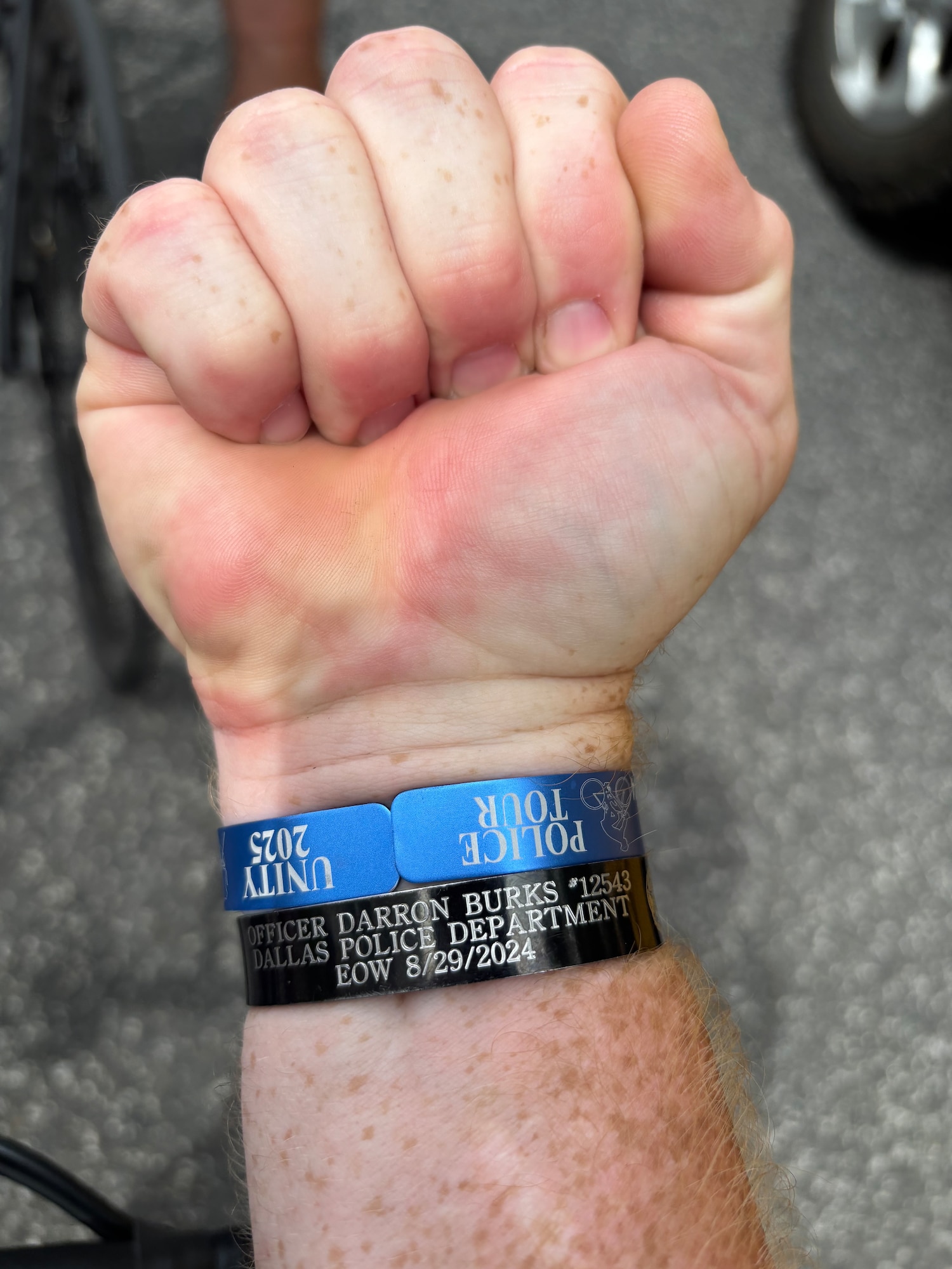 Photo of person wearing wristband to honor fallen police officer