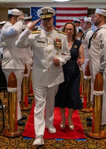 NAVAL STATION NORFOLK (Sept. 12, 2025) – Rear Adm. Carl Lahti and his family pass through the sideboys for the final time during a change of command and retirement ceremony held at Vista Point onboard Naval Station Norfolk, Sept. 12. CNRMA, now commanded by Rear Adm. Stephen Barnett, is the regional coordinator for all shore-based naval personnel and shore activities in the Mid-Atlantic region, which encompasses 20 states, 13 installations, and numerous Navy reserve centers from Maine to Virginia and as far west as Illinois. (U.S. Navy photo by Mass Communication Specialist 1st Class Kirk T. Putnam)
