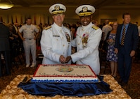 NAVAL STATION NORFOLK (Sept. 12, 2025) – Rear Adm. Carl Lahti and Commander, Navy Region Mid-Atlantic (CNRMA), Rear Adm. Stephen Barnett, cut the cake following a change of command and retirement ceremony held at Vista Point onboard Naval Station Norfolk, Sept. 12. CNRMA, now commanded by Rear Adm. Stephen Barnett, is the regional coordinator for all shore-based naval personnel and shore activities in the Mid-Atlantic region, which encompasses 20 states, 13 installations, and numerous Navy reserve centers from Maine to Virginia and as far west as Illinois. (U.S. Navy photo by Mass Communication Specialist 1st Class Kirk T. Putnam)