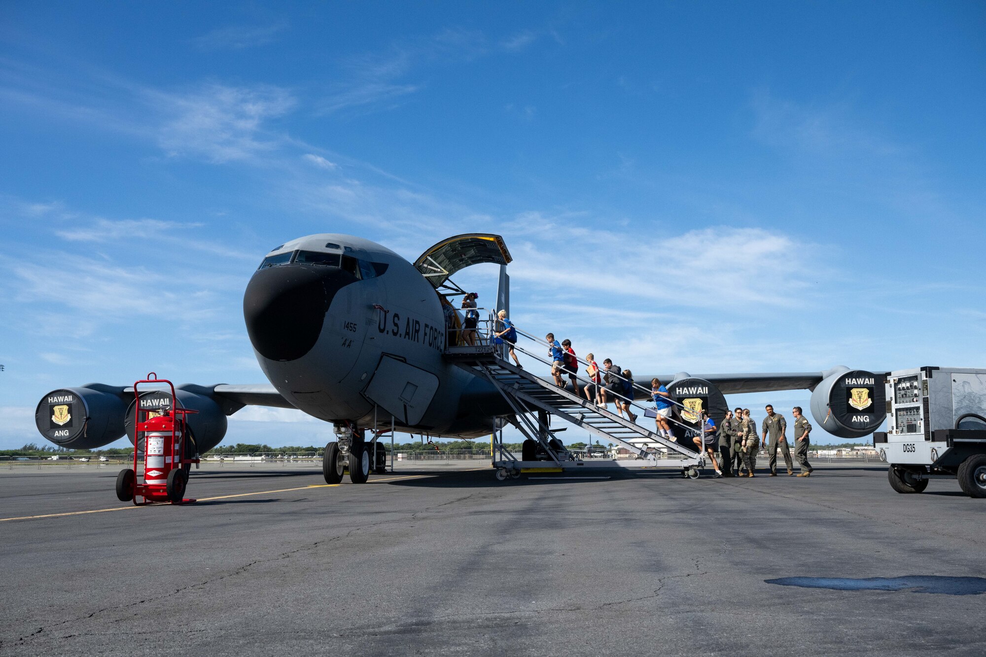 Students from across Oahu board a Kc-135 Stratotanker on the flightline of Joint Base Pearl Harbor-Hickam, Hawaii, during the Wings of Aloha Student Expo.
