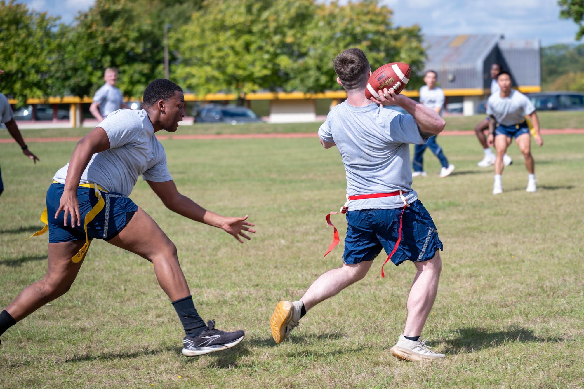 An Airman attempts a pass during a flag football game