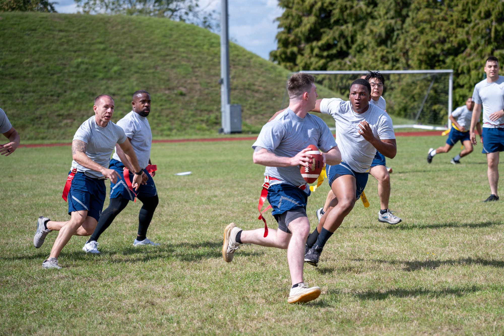 An Airman runs the ball during a flag football game