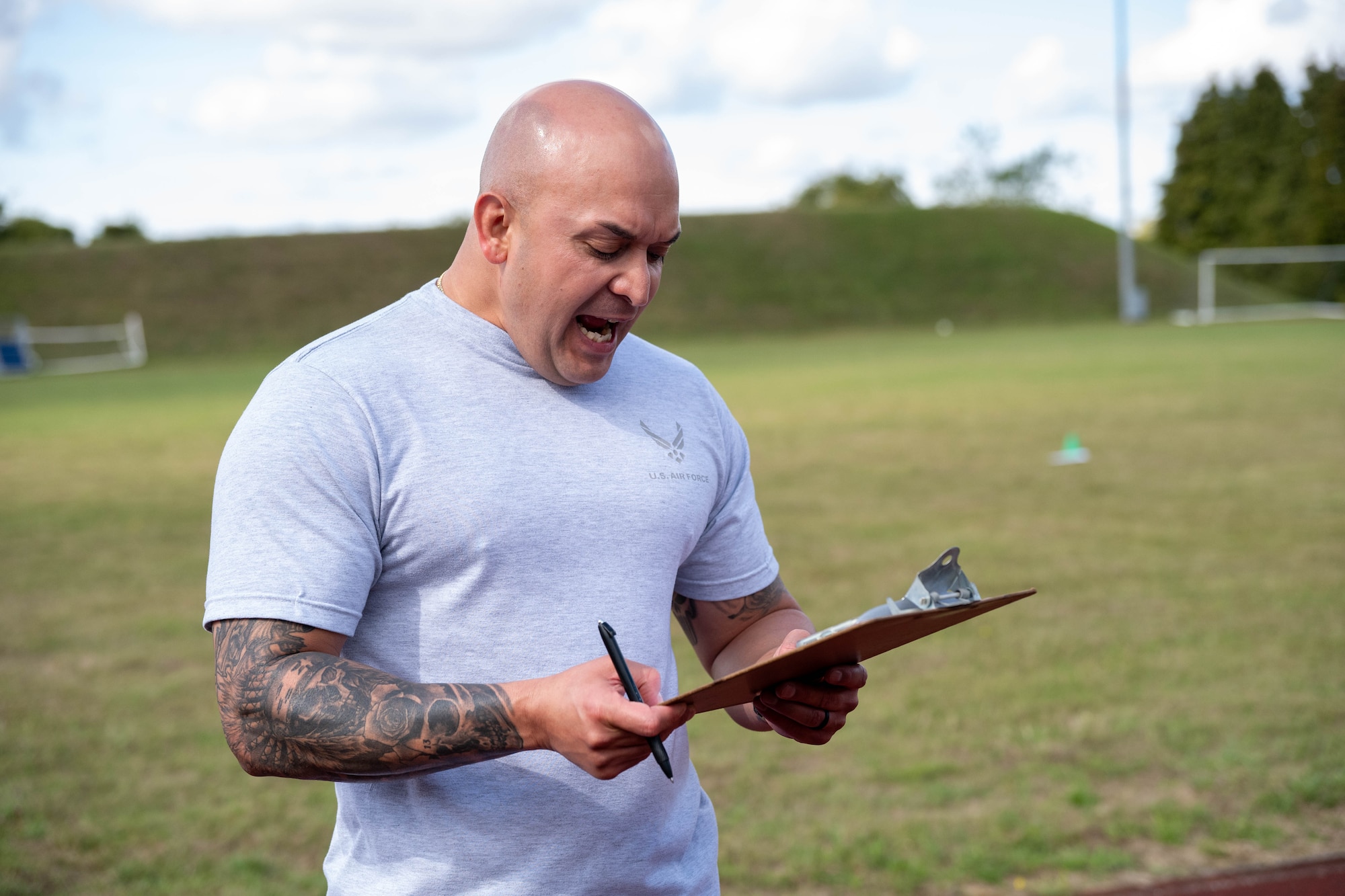 An Airman keeps score during a combat fitness challenge
