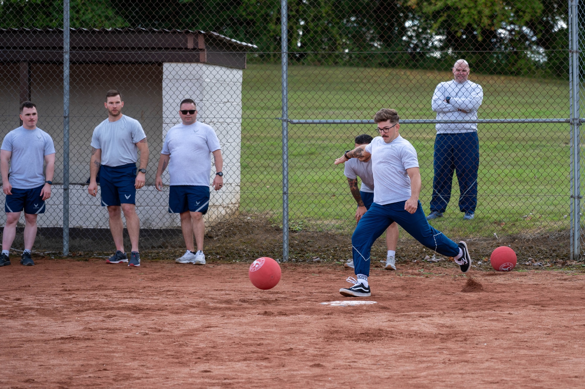 An Airman prepares to kick during a kickball game