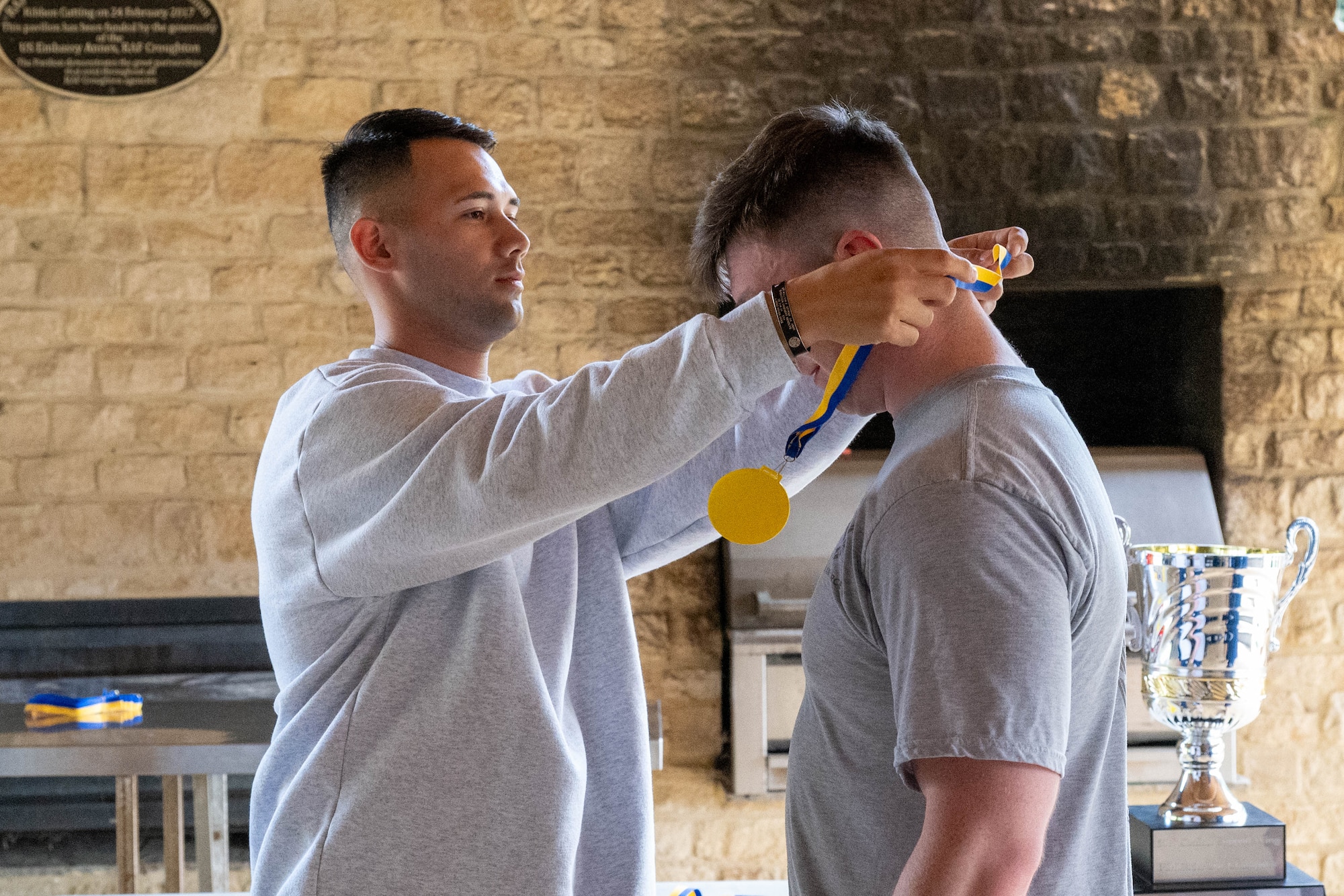 An Airman presents a medal during the Pathfinder Day awards ceremony