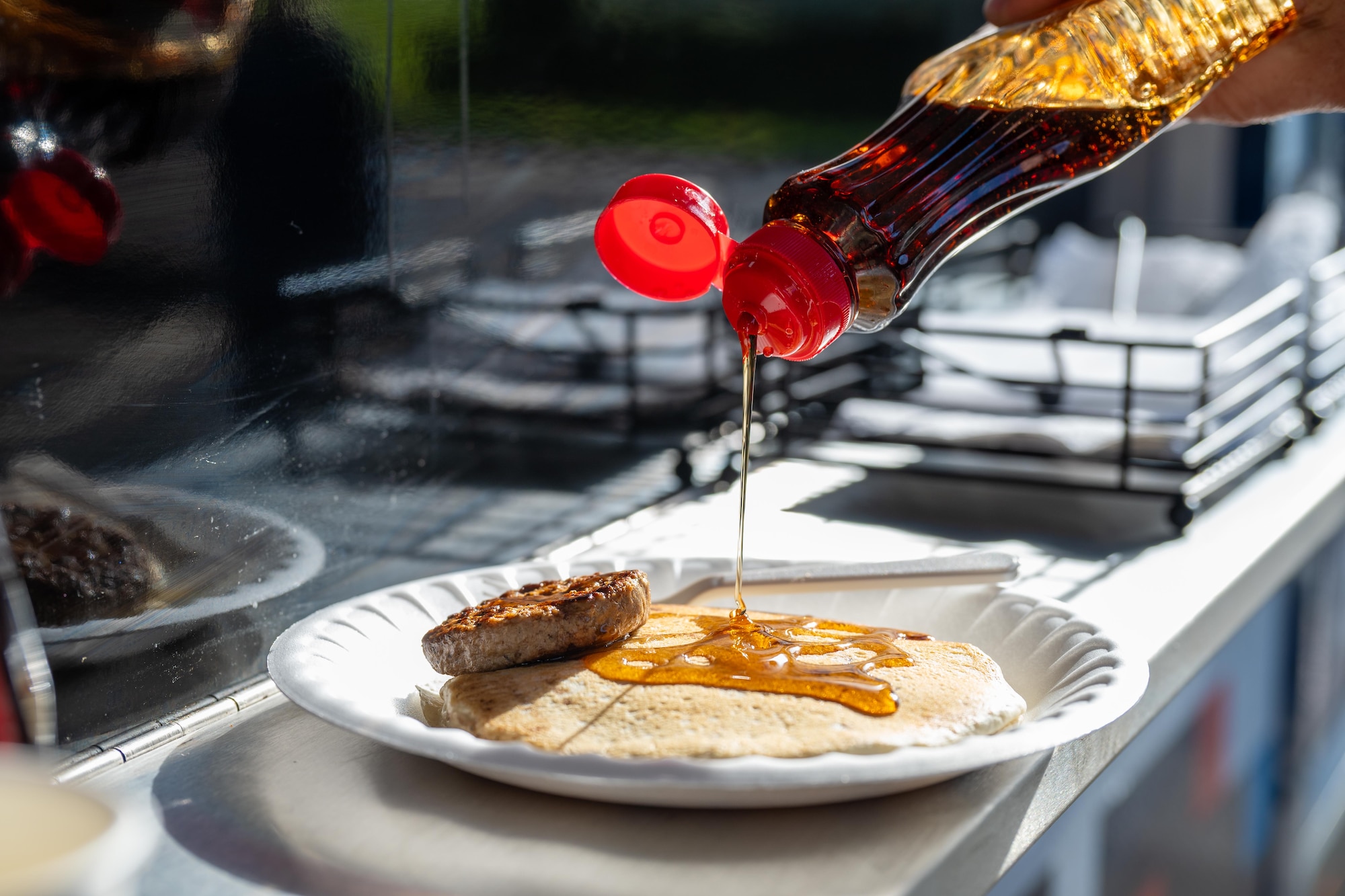 Syrup is poured over pancakes