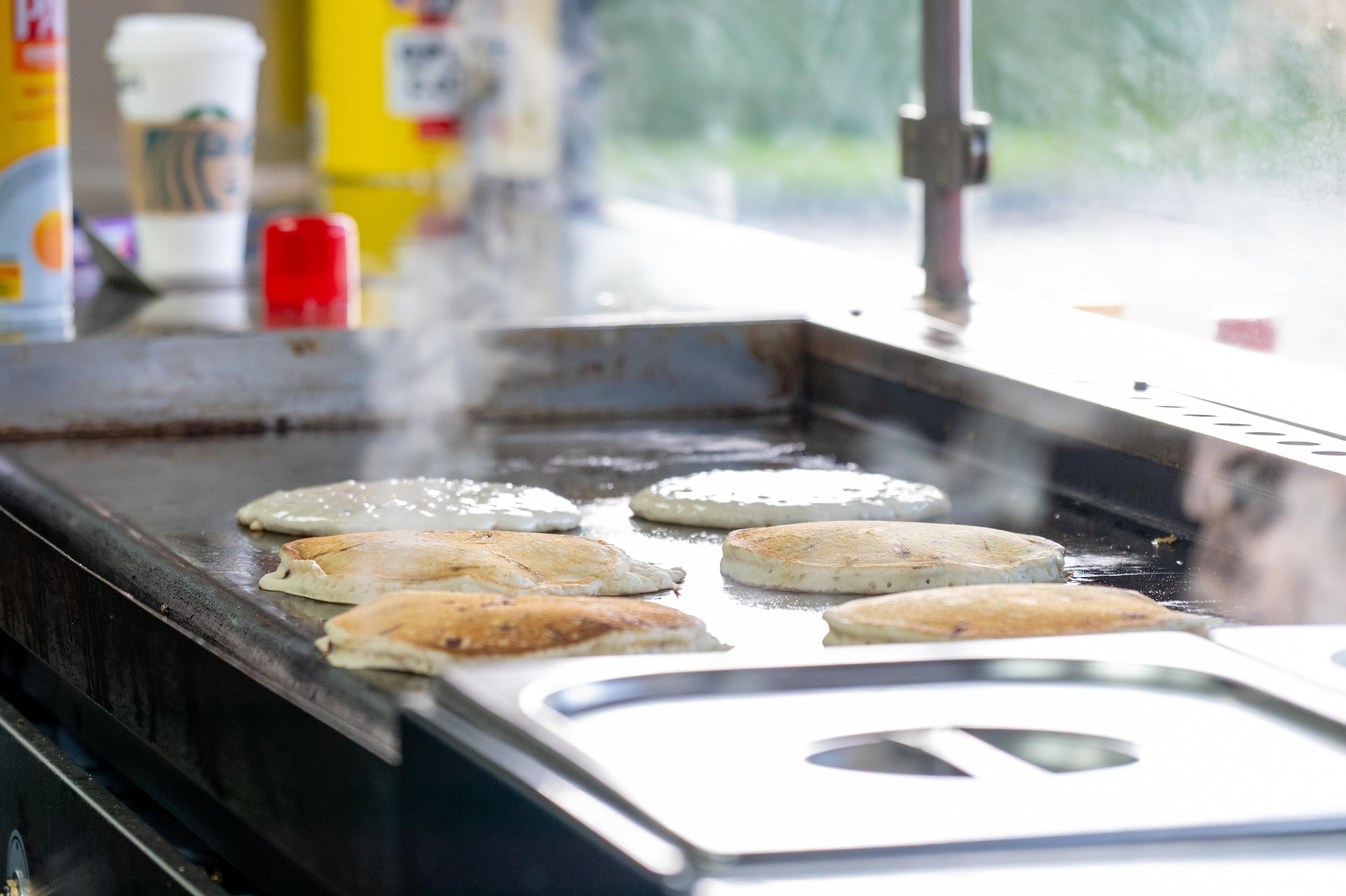 Pancakes cook on a griddle