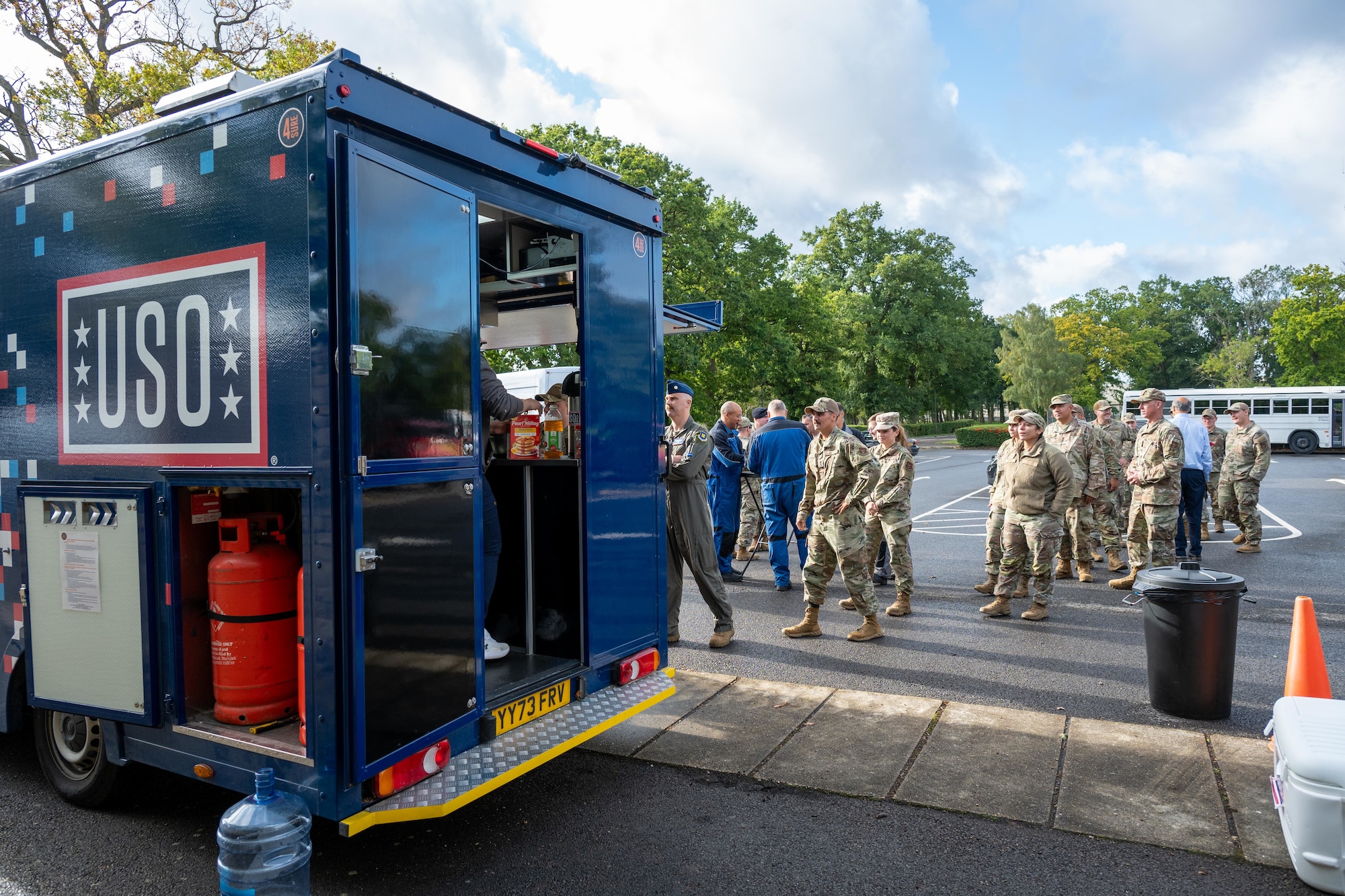 Airmen line up outside the USO “Big Ben” food truck