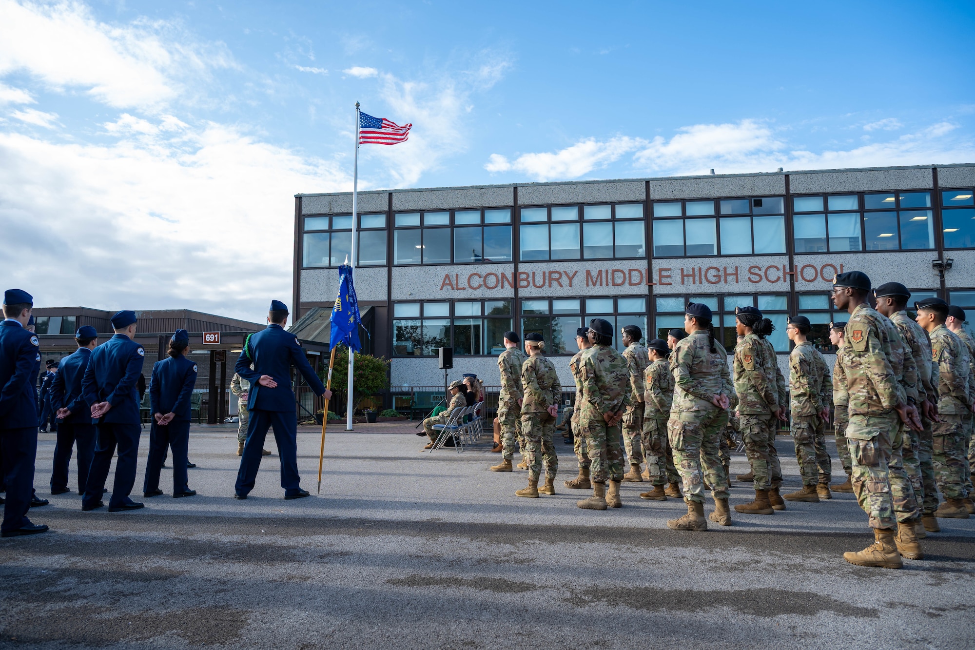 U.S. Air Force Airmen and Junior ROTC cadets stand in formation during a 9/11 memorial ceremony