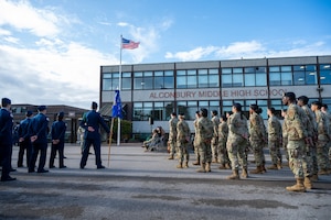 U.S. Air Force Airmen and Junior ROTC cadets stand in formation during a 9/11 memorial ceremony