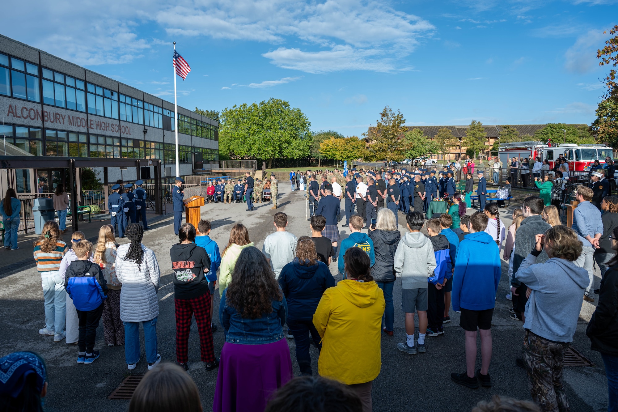 Airmen, students, and community members gather for a 9/11 memorial ceremony