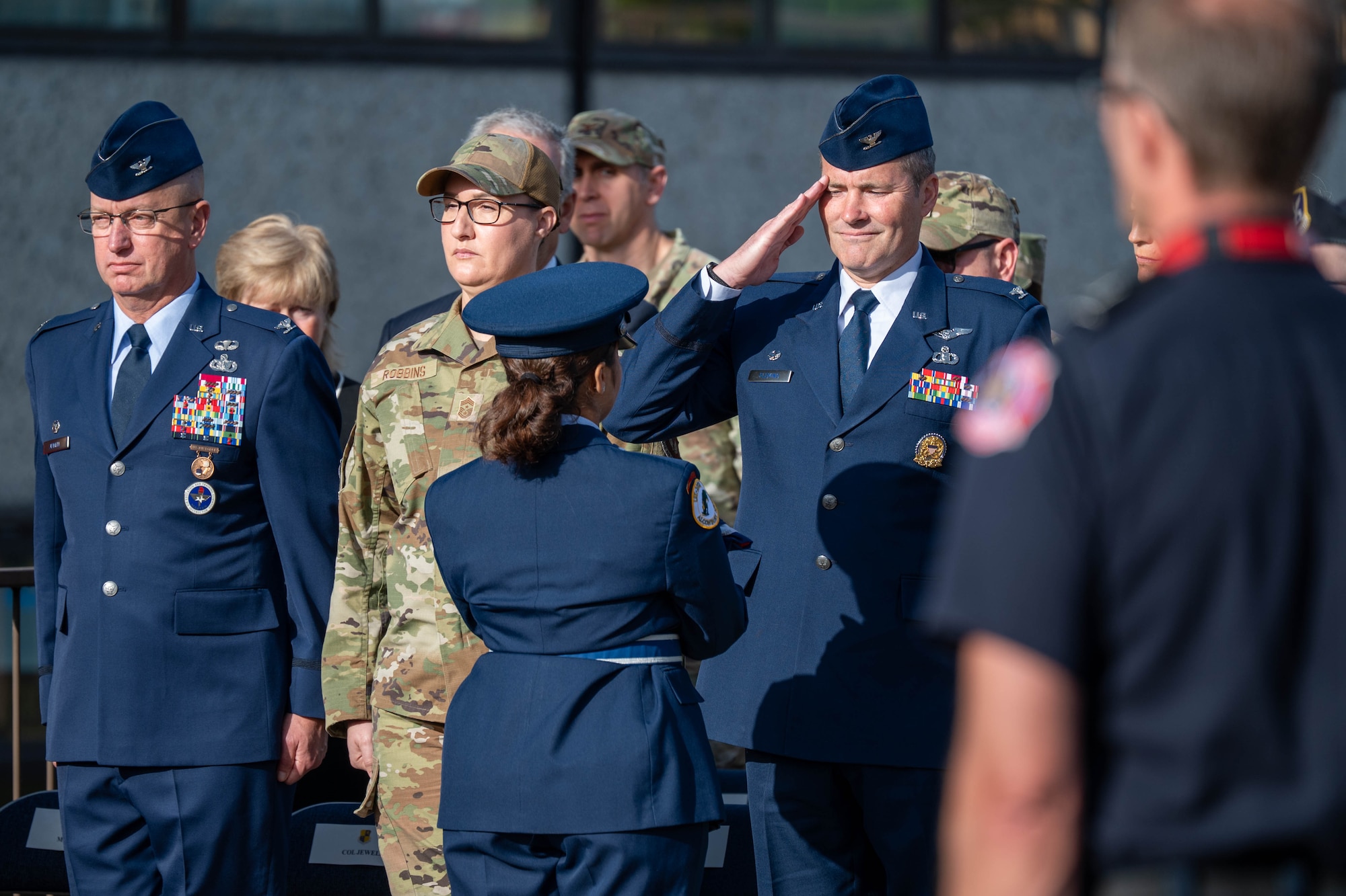 Col. Michael G. Fleming accepts an American flag during a 9/11 memorial ceremony