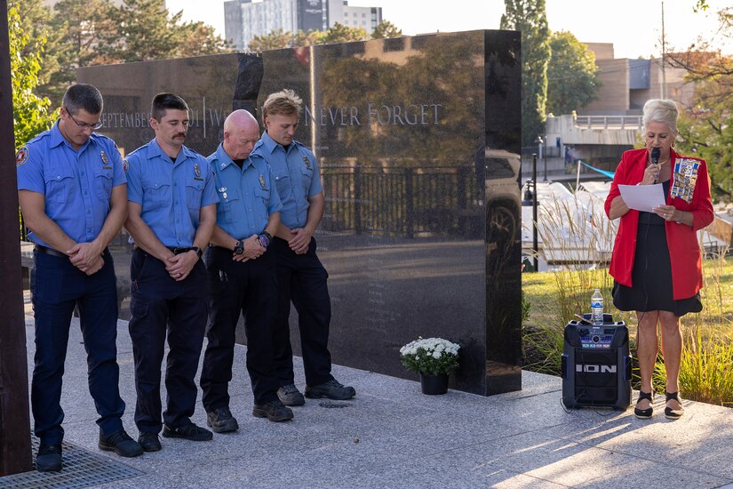 Jill Fewell, Daughters of the American Revolution Caroline Scott Harrison Chapter regent, leads a prayer alongside firefighters from the Indianapolis Fire Department’s Station 13 during a commemoration ceremony at the Indiana 9/11 Memorial in Indianapolis Sept. 11, 2025. Soldiers and civilians from the U.S. Army Financial Management Command joined the DAR, IFD, police officers from various agencies and members of the public to commemorate the 24th anniversary of the terrorist attacks on Sept. 11, 2001. (U.S. Army photo by Mark R. W. Orders-Woempner)
