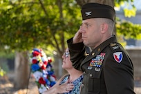 U.S. Army Col. Shaun D. McMurchie, 45th Finance Center director, and his wife, Amy McMurchie, pay honors to the American Flag as the National Anthem is played during a commemoration ceremony at the Indiana 9/11 Memorial in Indianapolis Sept. 11, 2025. Soldiers and civilians from the U.S. Army Financial Management Command joined the Daughters of the American Revolution Caroline Scott Harrison Chapter, the Indianapolis Fire Department’s Station 13, police officers from various agencies and members of the public to commemorate the 24th anniversary of the terrorist attacks on Sept. 11, 2001. (U.S. Army photo by Mark R. W. Orders-Woempner)
