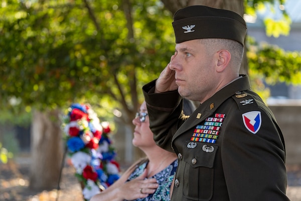 U.S. Army Col. Shaun D. McMurchie, 45th Finance Center director, and his wife, Amy McMurchie, pay honors to the American Flag as the National Anthem is played during a commemoration ceremony at the Indiana 9/11 Memorial in Indianapolis Sept. 11, 2025. Soldiers and civilians from the U.S. Army Financial Management Command joined the Daughters of the American Revolution Caroline Scott Harrison Chapter, the Indianapolis Fire Department’s Station 13, police officers from various agencies and members of the public to commemorate the 24th anniversary of the terrorist attacks on Sept. 11, 2001. (U.S. Army photo by Mark R. W. Orders-Woempner)