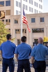 Firefighters from the Indianapolis Fire Department’s Station 13 pay honors to the American Flag during the National Anthem during a commemoration ceremony at the Indiana 9/11 Memorial in Indianapolis Sept. 11, 2025. Standing between the firefighters and the flag was a beam from one of the towers at the World Trade Center, which was destroyed by the terrorist attacks on Sept. 11, 2001. (U.S. Army photo by Mark R. W. Orders-Woempner)