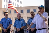 Greg Hess, retired Indianapolis Fire Department firefighter and paramedic, delivers remarks about his time at Ground Zero, his subsequent cancer struggles resulting from his time there, and his 22-month effort to establish the Indiana 9/11 Memorial as IFD firefighters from Station 13 listen during a commemoration ceremony at the memorial in Indianapolis Sept. 11, 2025. In 2001, Hess was a member of Indiana Task Force 1, which spent eight days in New York assisting the local agencies in the rescue and recovery efforts. (U.S. Army photo by Mark R. W. Orders-Woempner)